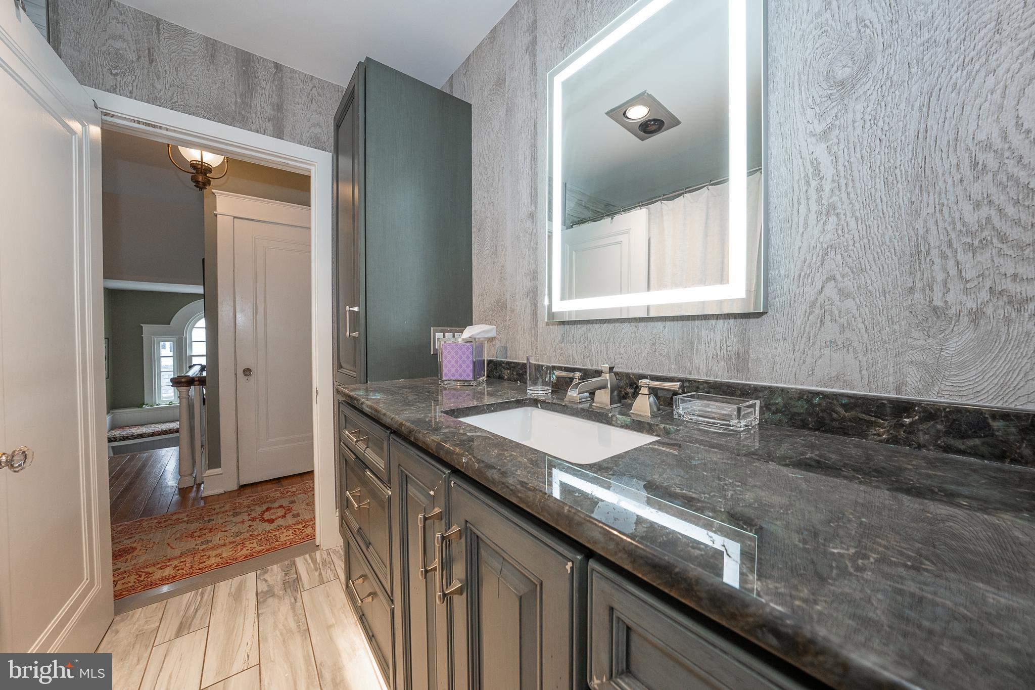 9 Shirley Road Narberth, PA 19072 - Photo 48 of 87 a bathroom with a granite countertop sink and a mirror