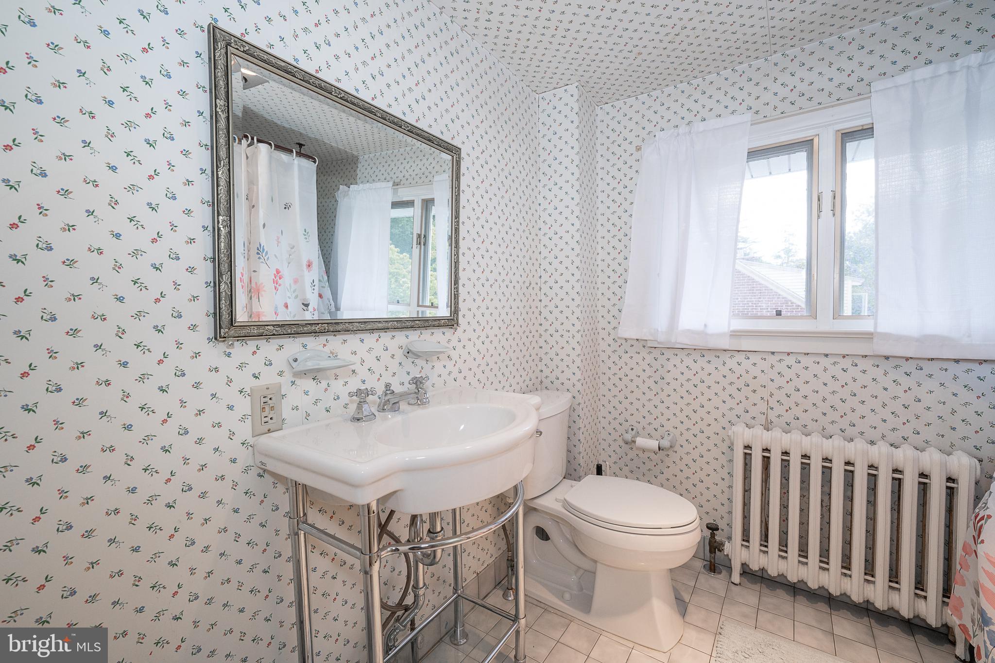 9 Shirley Road Narberth, PA 19072 - Photo 62 of 87 a bathroom with a toilet a sink and mirror