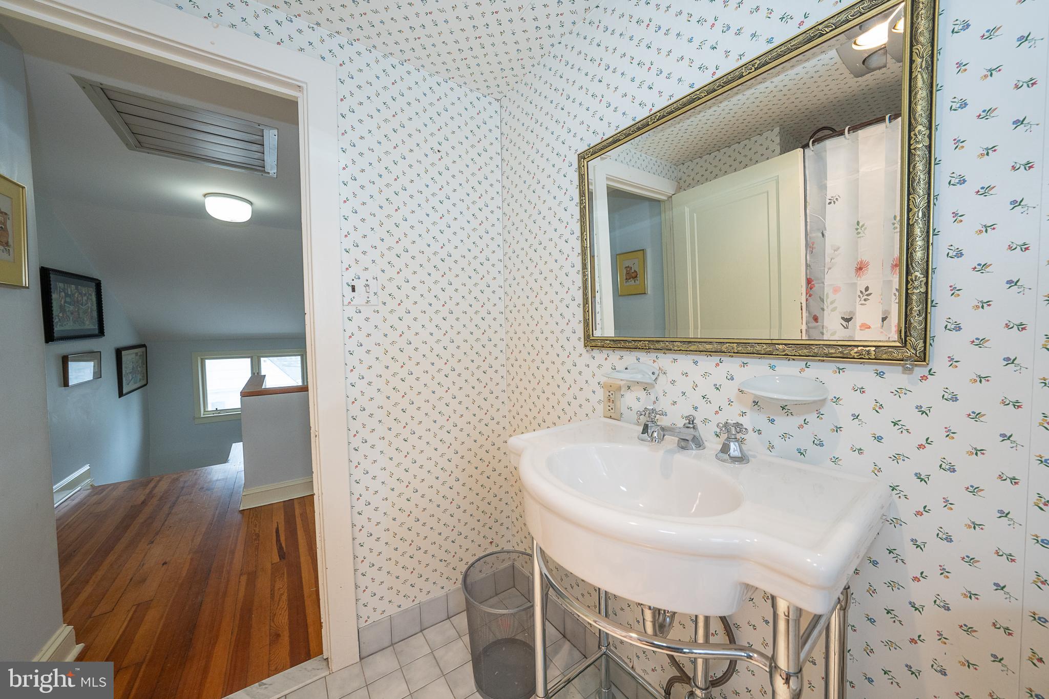 9 Shirley Road Narberth, PA 19072 - Photo 63 of 87 a bathroom with a sink and a mirror