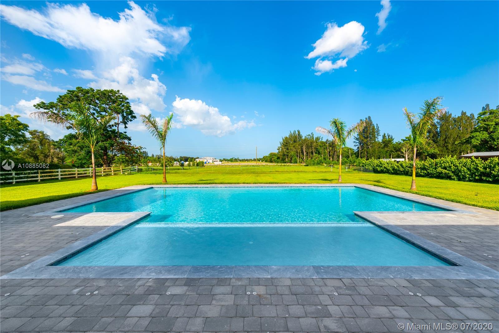 6122 Southwest 173rd Way Southwest Ranches, FL 33331 - Photo 27 of 29 a view of a swimming pool with an outdoor space and seating area