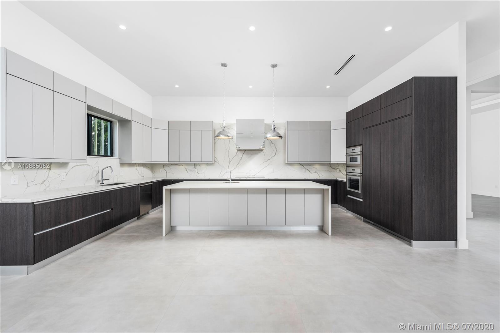 6122 Southwest 173rd Way Southwest Ranches, FL 33331 - Photo 7 of 29 a large kitchen with a large counter top stainless steel appliances and cabinets