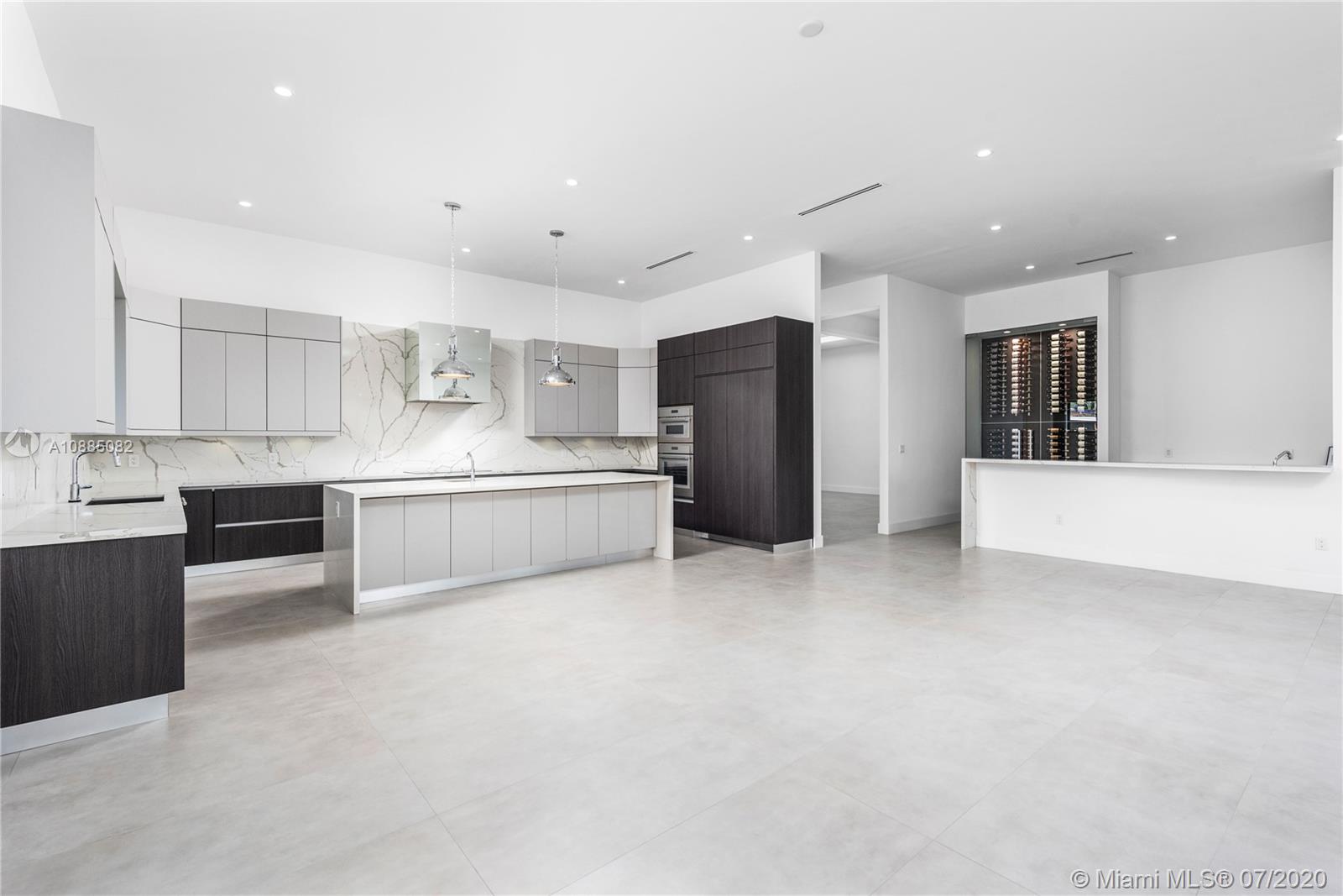 6122 Southwest 173rd Way Southwest Ranches, FL 33331 - Photo 8 of 29 a large white kitchen with stainless steel appliances kitchen island a large counter top and a refrigerator