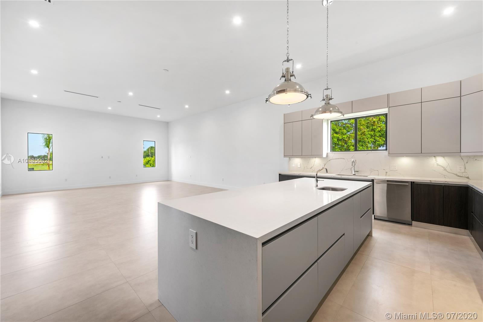 6122 Southwest 173rd Way Southwest Ranches, FL 33331 - Photo 9 of 29 a kitchen with a stove a chandelier and a sink