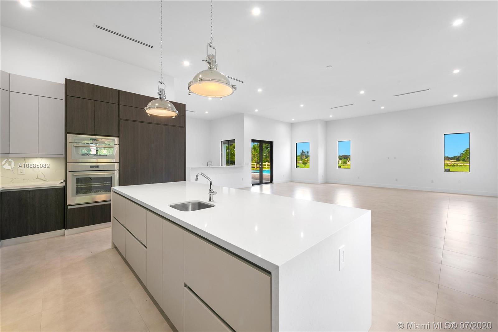 6122 Southwest 173rd Way Southwest Ranches, FL 33331 - Photo 10 of 29 a kitchen with stainless steel appliances granite countertop a sink and a refrigerator