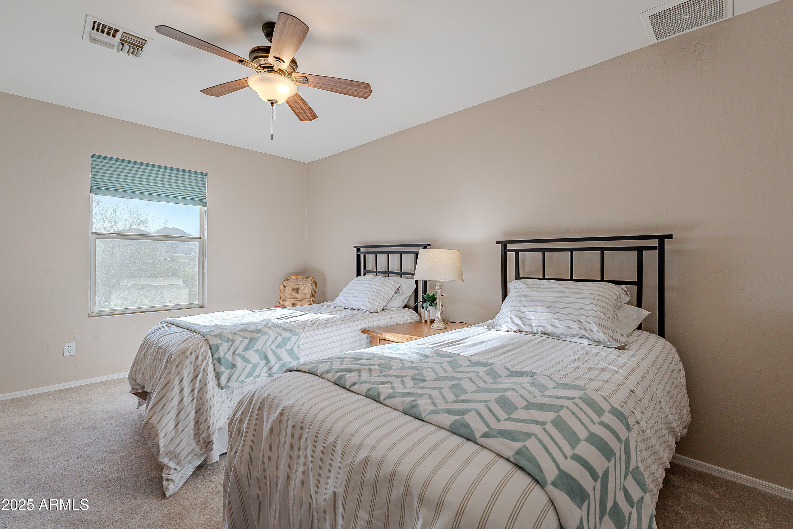 5960 East Grapevine Road Cave Creek, AZ 85331 - Photo 15 of 54 a bedroom with a bed and window