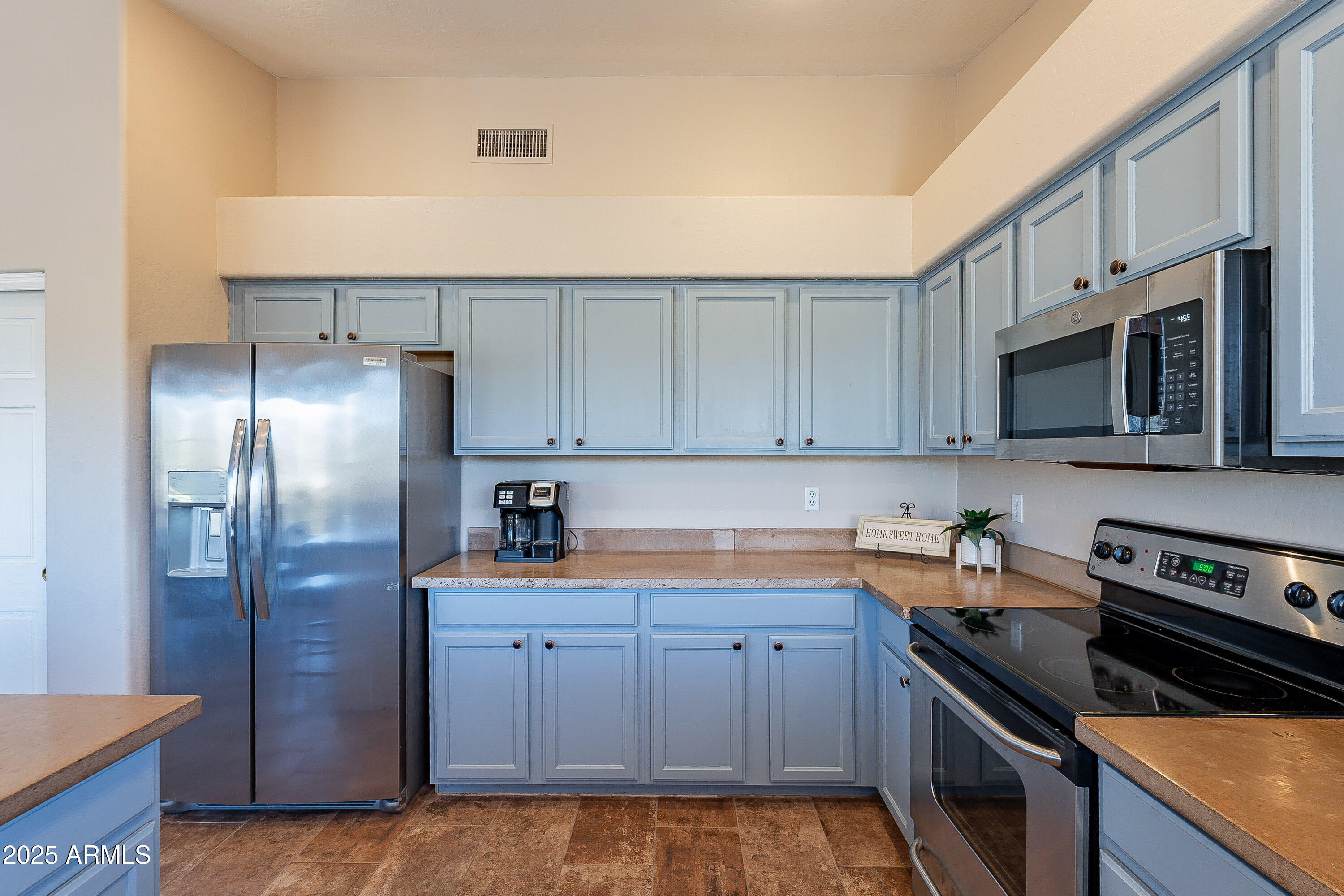 5960 East Grapevine Road Cave Creek, AZ 85331 - Photo 22 of 54 a kitchen with stainless steel appliances granite countertop a refrigerator sink and stove
