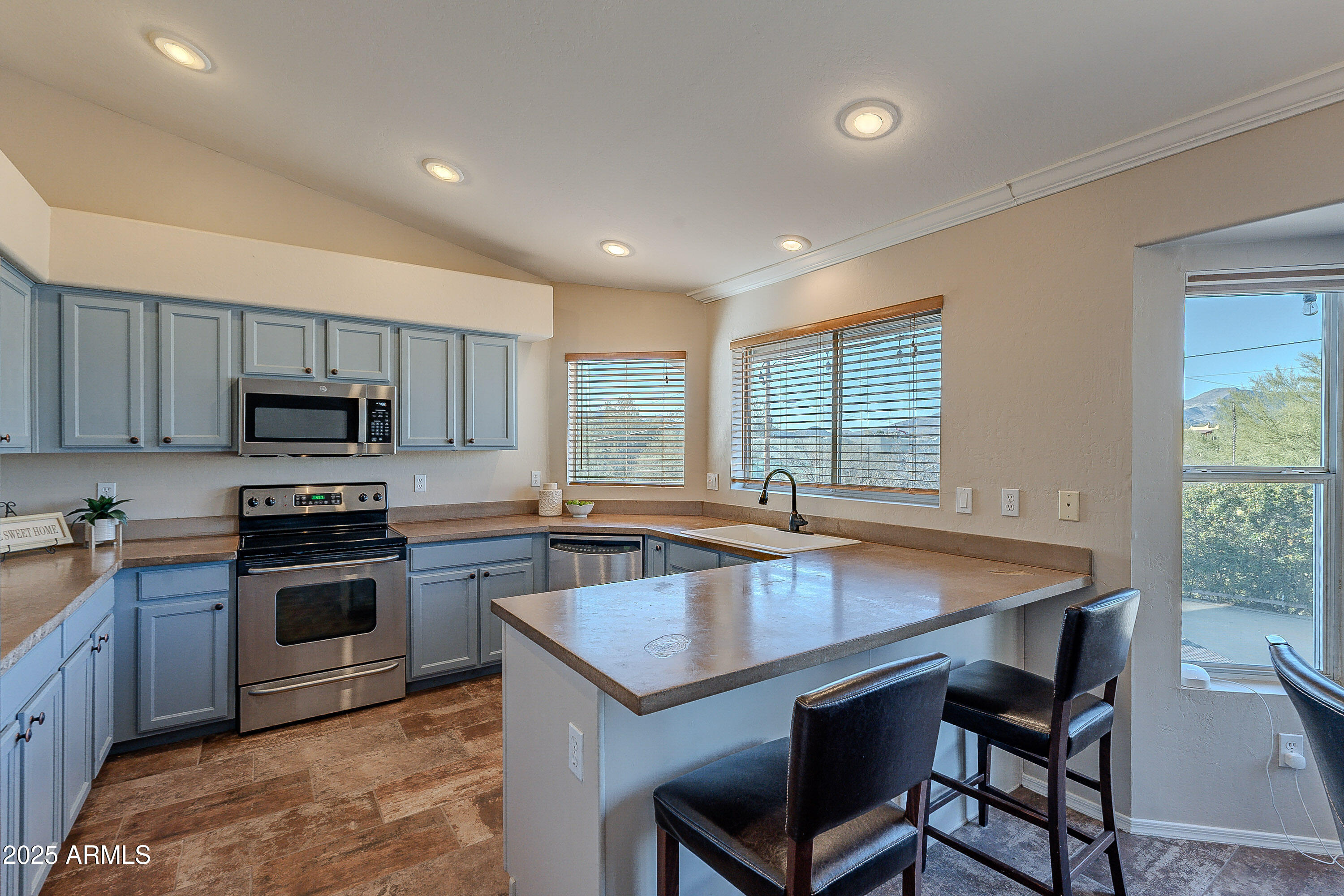 5960 East Grapevine Road Cave Creek, AZ 85331 - Photo 23 of 54 a kitchen with a stove a sink and a refrigerator