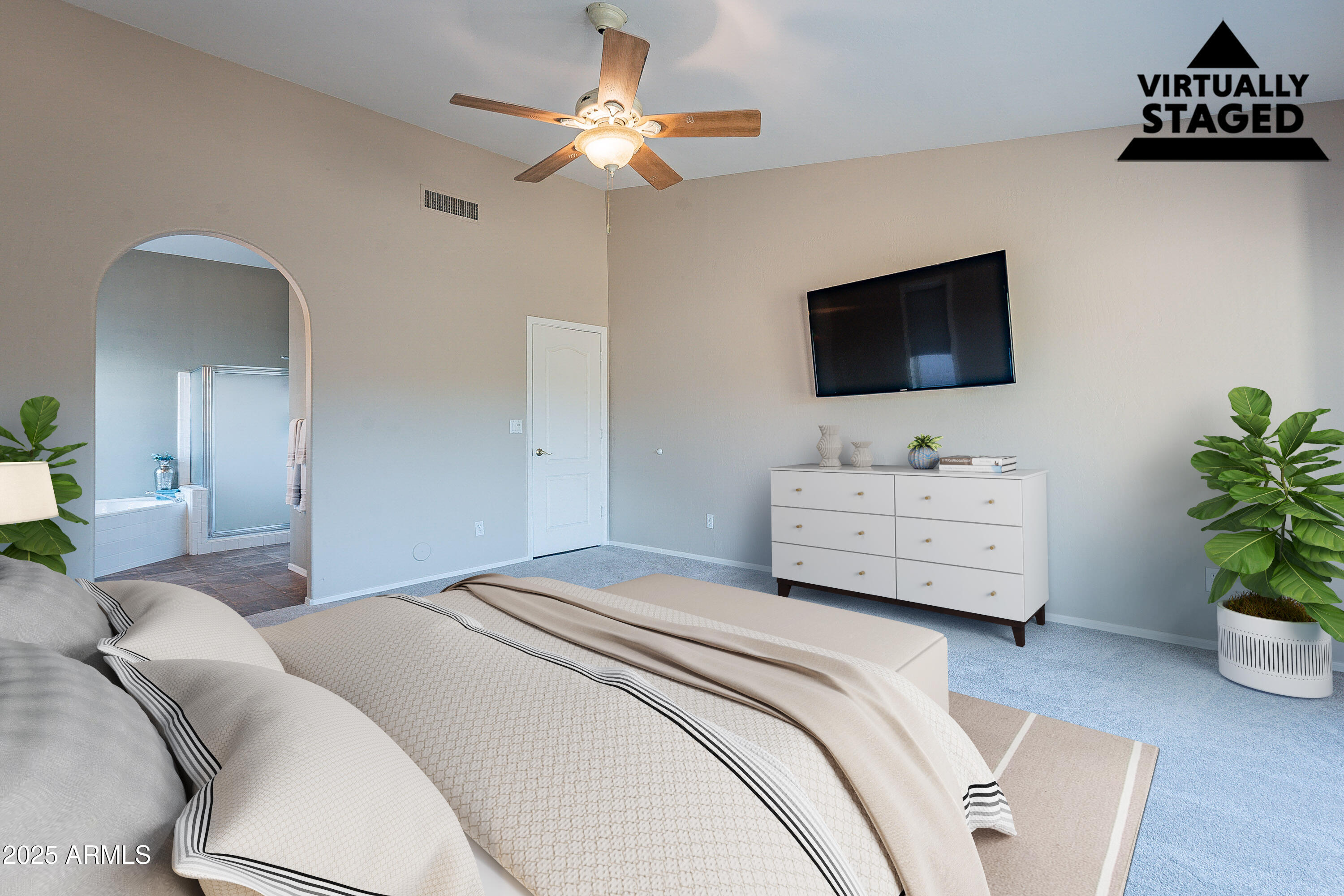 5960 East Grapevine Road Cave Creek, AZ 85331 - Photo 25 of 54 a bedroom with a bed a flat screen tv and a couch