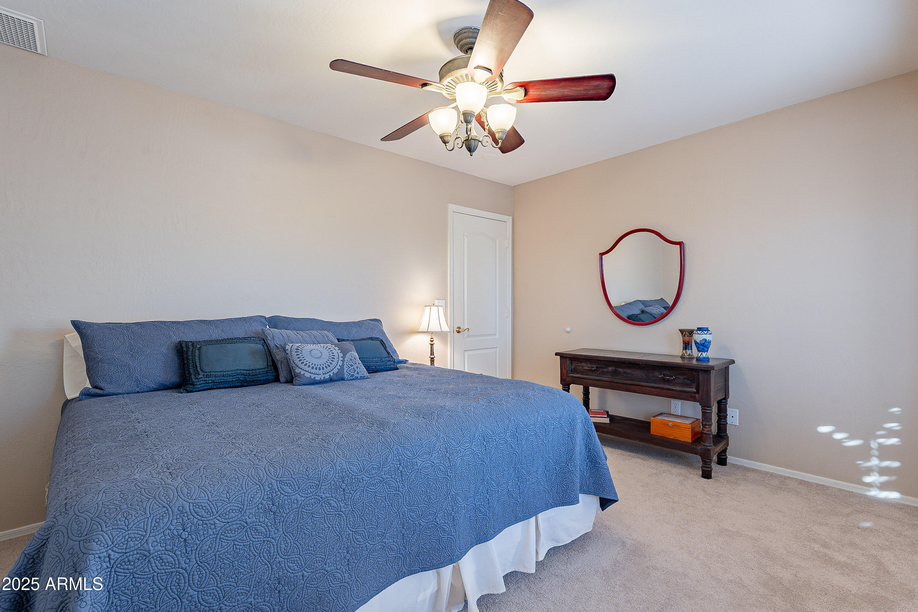 5960 East Grapevine Road Cave Creek, AZ 85331 - Photo 30 of 54 a bedroom with a bed and a chandelier