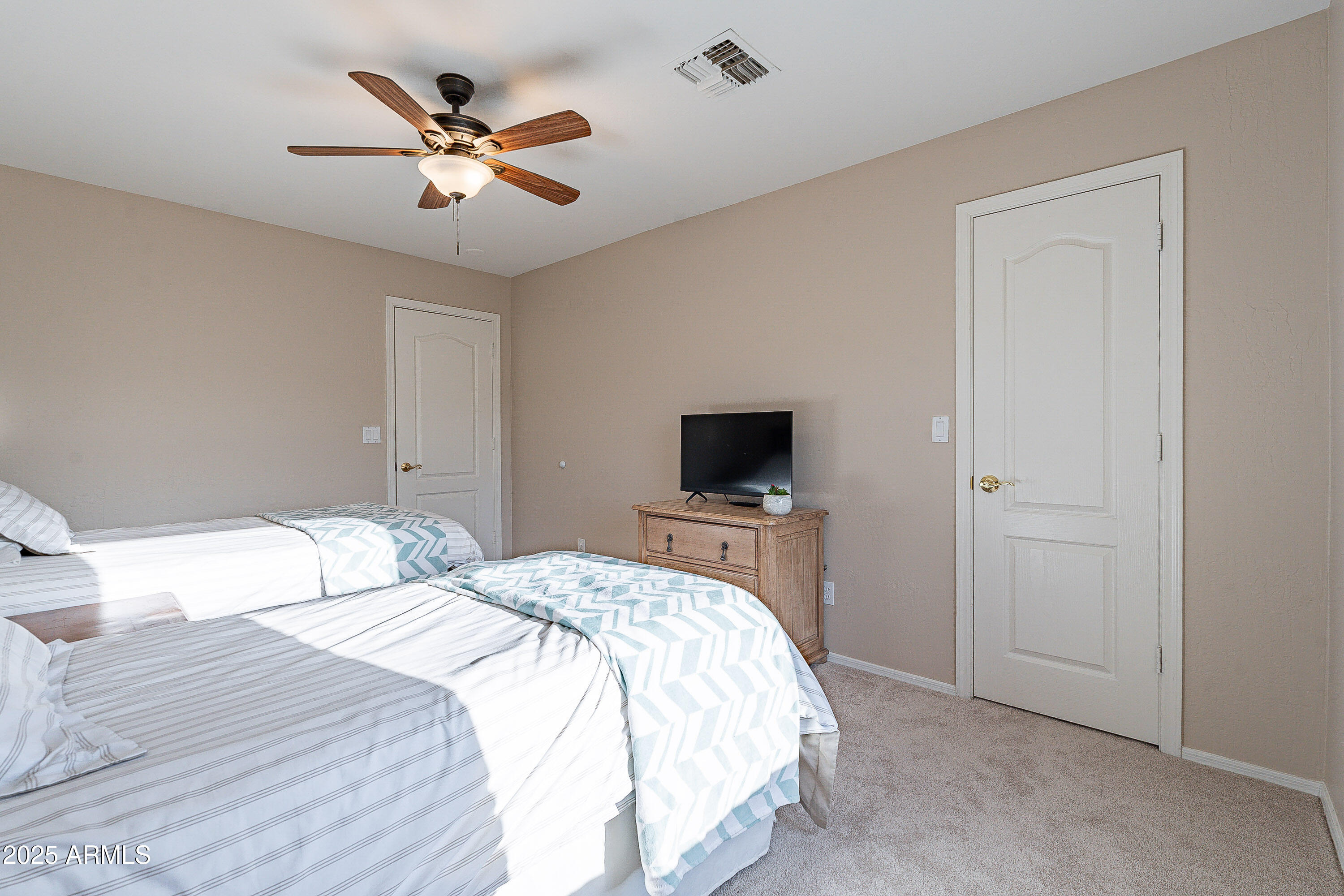 5960 East Grapevine Road Cave Creek, AZ 85331 - Photo 33 of 54 a bedroom with a bed and a tv