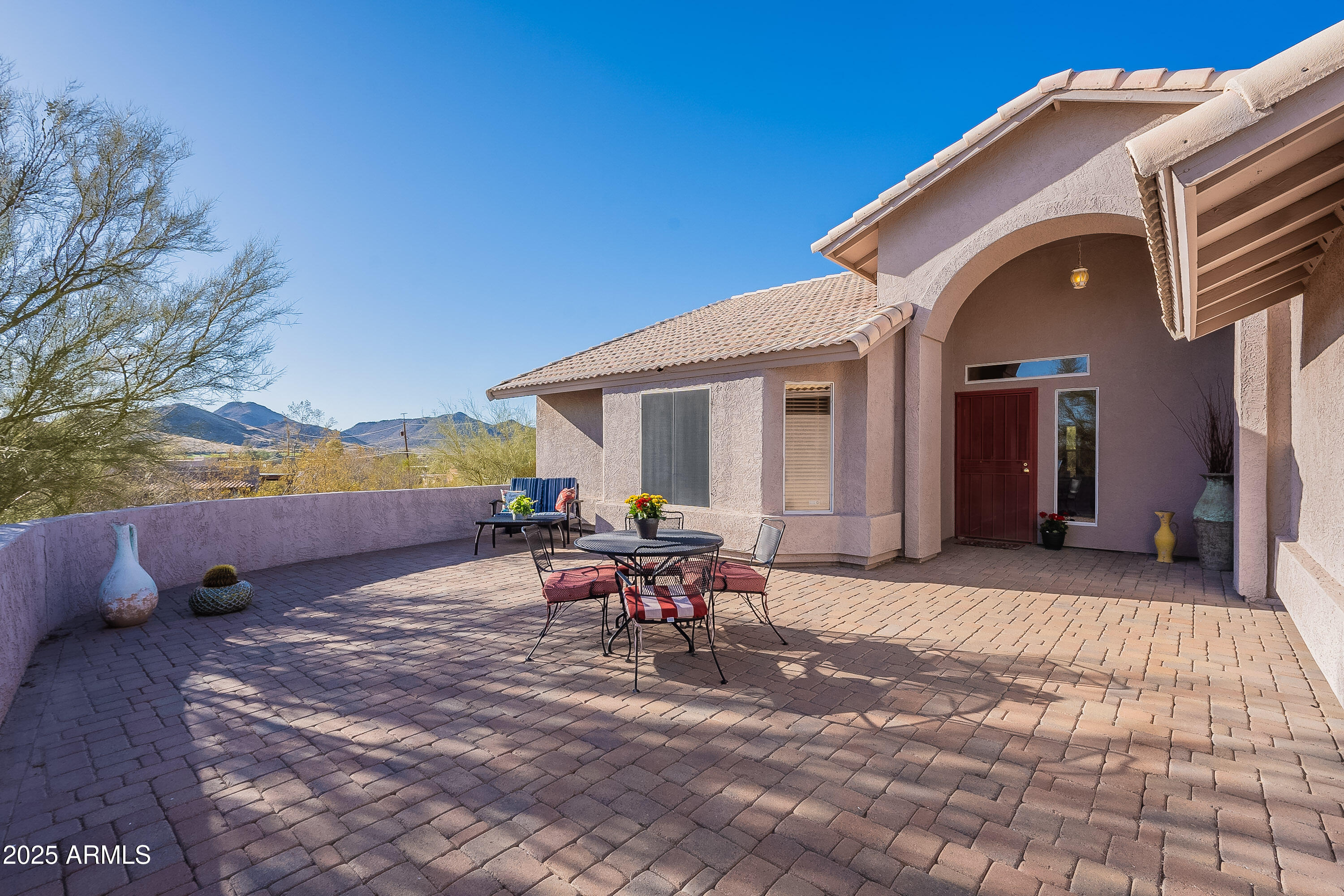 5960 East Grapevine Road Cave Creek, AZ 85331 - Photo 49 of 54 a view of a patio with table and chairs and potted plants