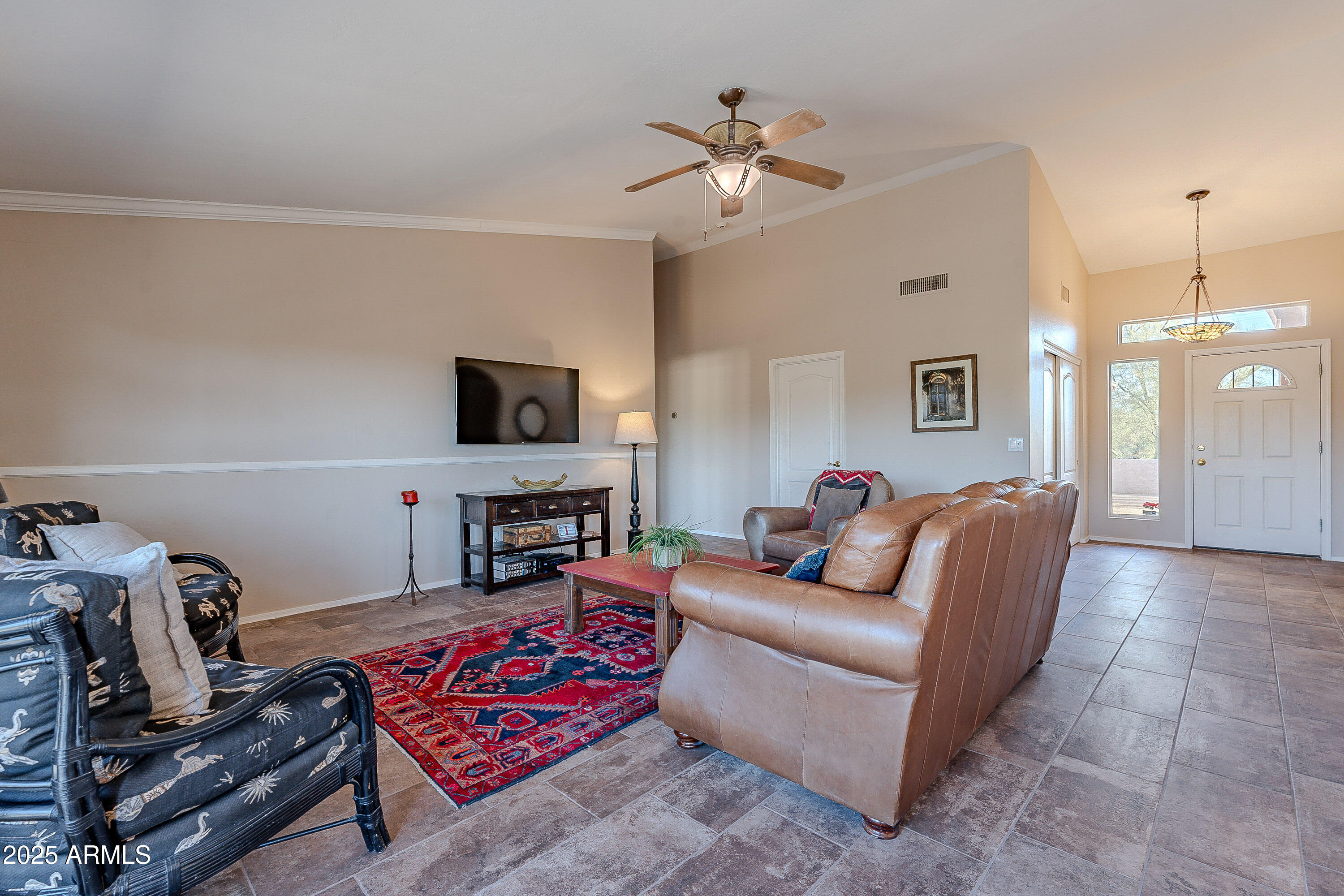 5960 East Grapevine Road Cave Creek, AZ 85331 - Photo 7 of 54 a living room with furniture and a flat screen tv