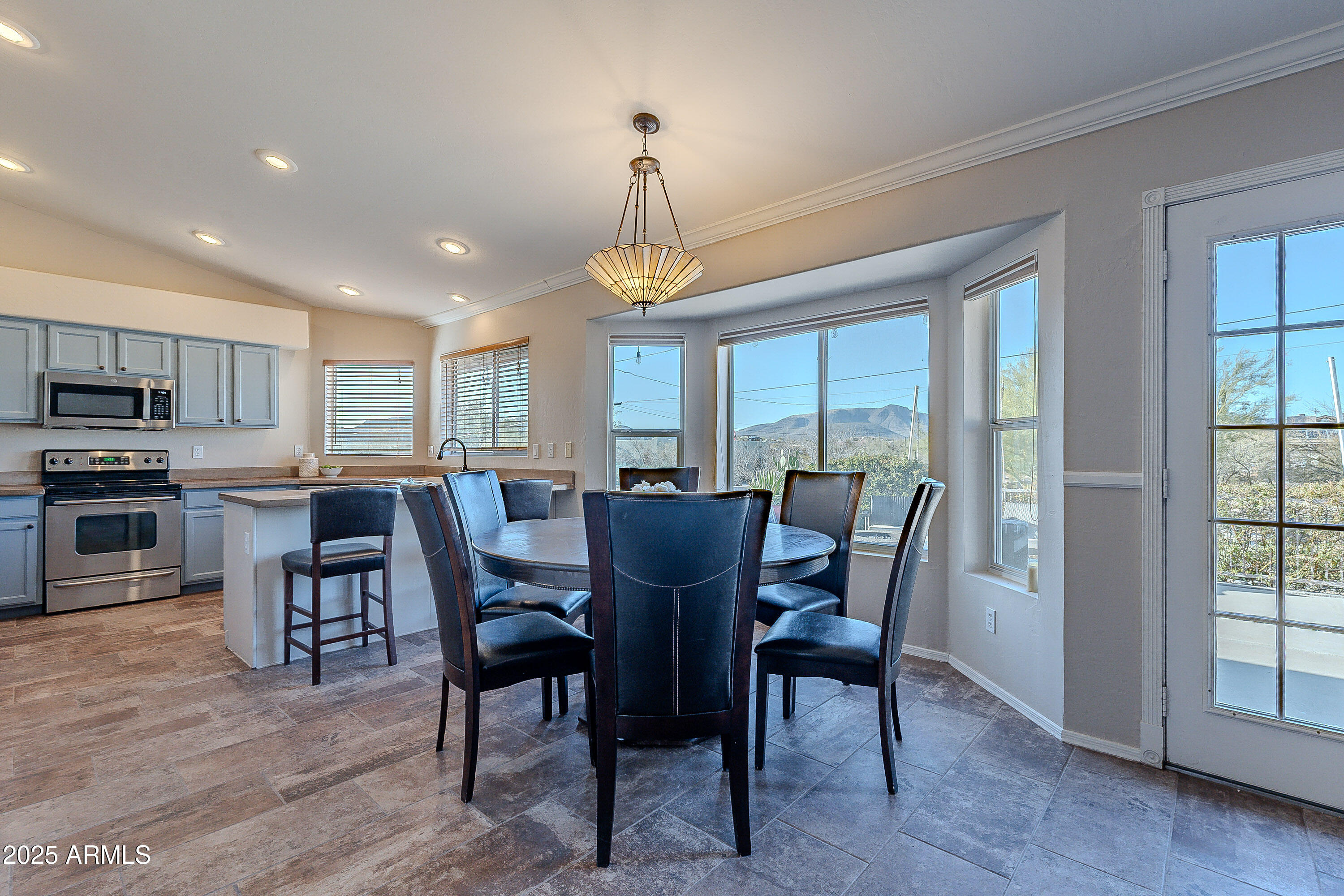 5960 East Grapevine Road Cave Creek, AZ 85331 - Photo 8 of 54 a view of a dining room with furniture window and wooden floor