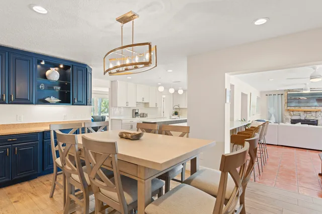 a large kitchen with kitchen island a large counter top space a sink stainless steel appliances and cabinets