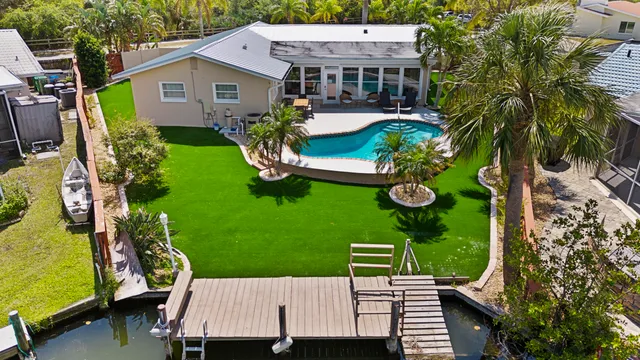an aerial view of a house with garden space and street view