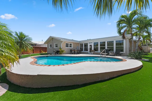 a view of swimming pool with outdoor seating and deck