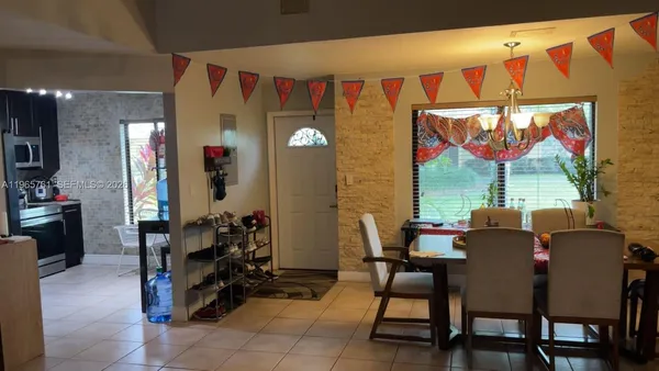 a dining room with furniture and window