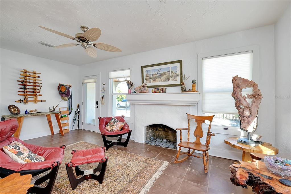 223 Palmetto Road West Nokomis, FL 34275 - Photo 15 of 100 a living room with furniture a fireplace and paintings on the wall