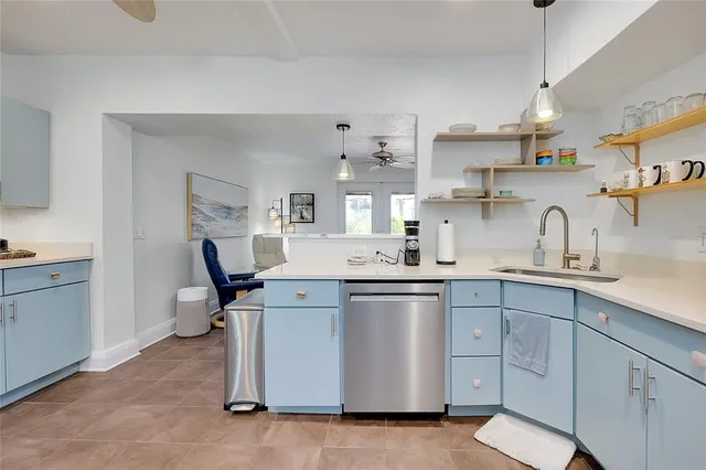 a bedroom with a large bed a chandelier and dresser