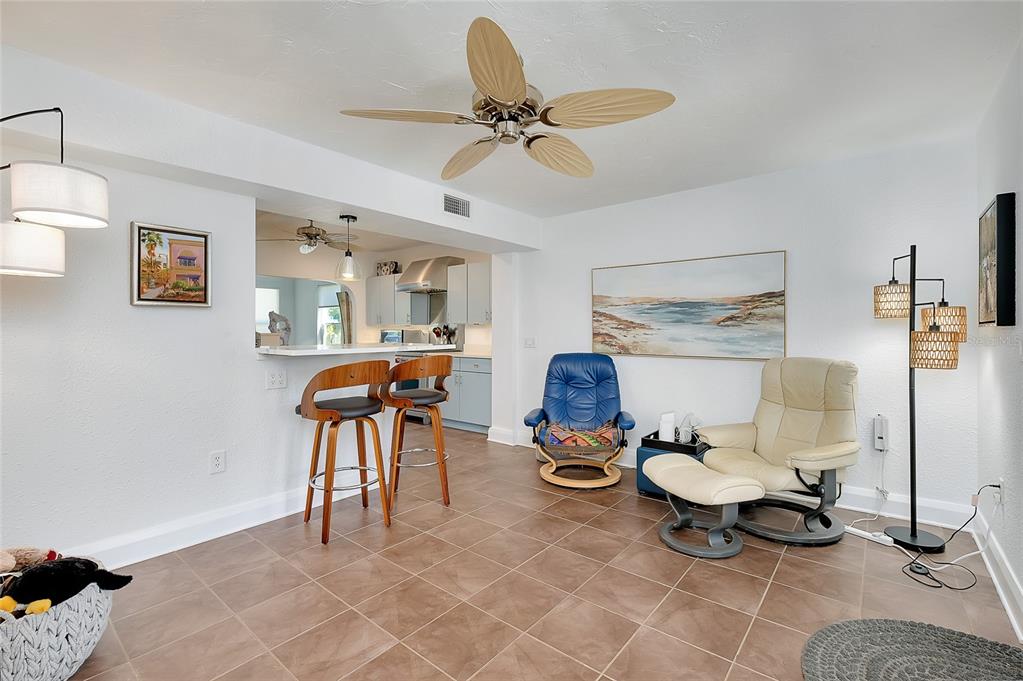 223 Palmetto Road West Nokomis, FL 34275 - Photo 27 of 100 a living room with furniture a rug and a ceiling fan