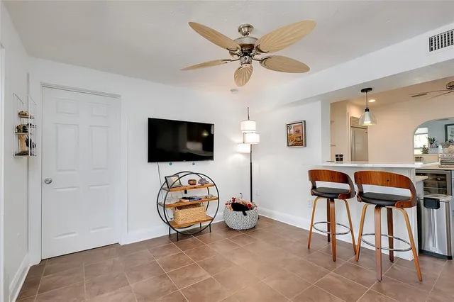 a living room with furniture and a mirror