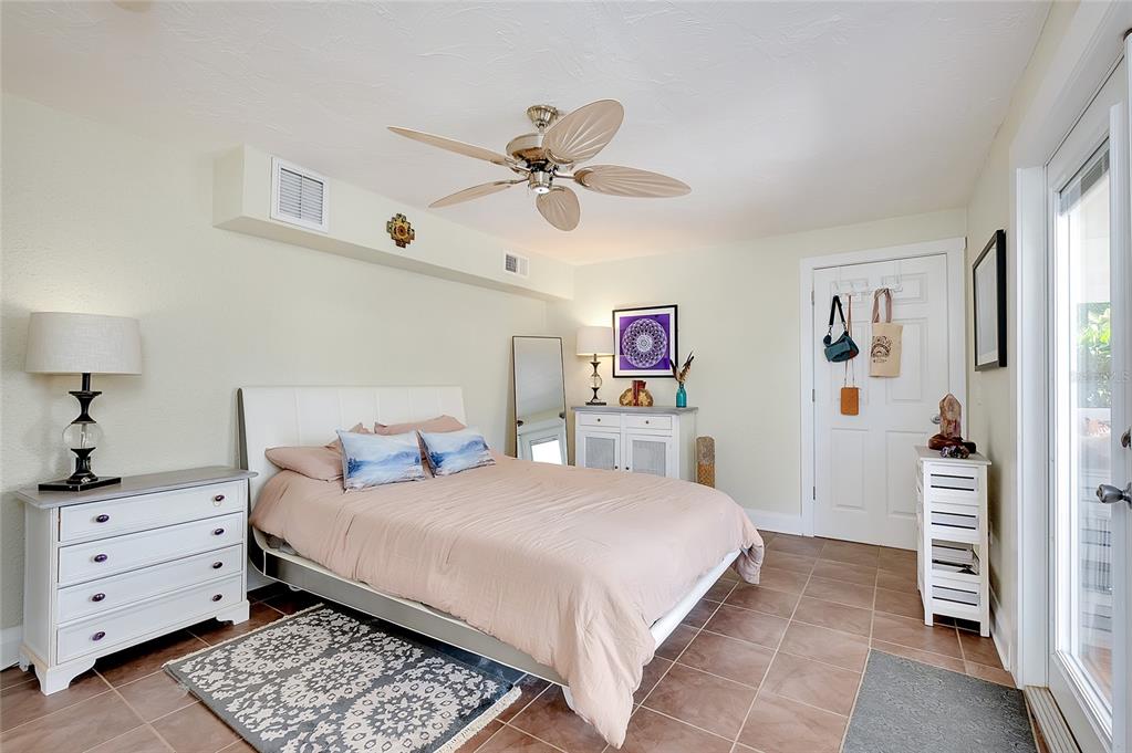 223 Palmetto Road West Nokomis, FL 34275 - Photo 31 of 100 a bedroom with a bed and a chandelier