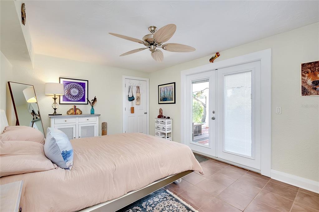 223 Palmetto Road West Nokomis, FL 34275 - Photo 32 of 100 a bedroom with a large bed a chandelier and dresser