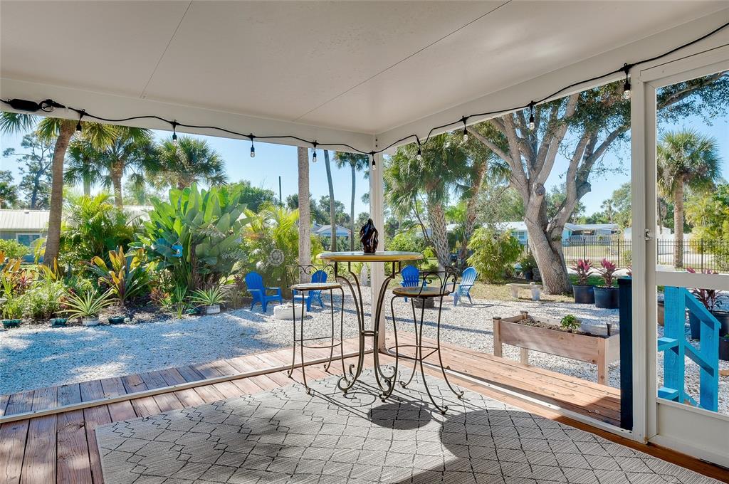 223 Palmetto Road West Nokomis, FL 34275 - Photo 58 of 100 a view of a porch with chairs and backyard