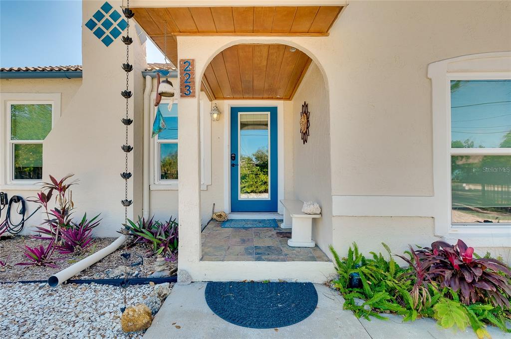 223 Palmetto Road West Nokomis, FL 34275 - Photo 6 of 100 a front view of a house with outdoor seating