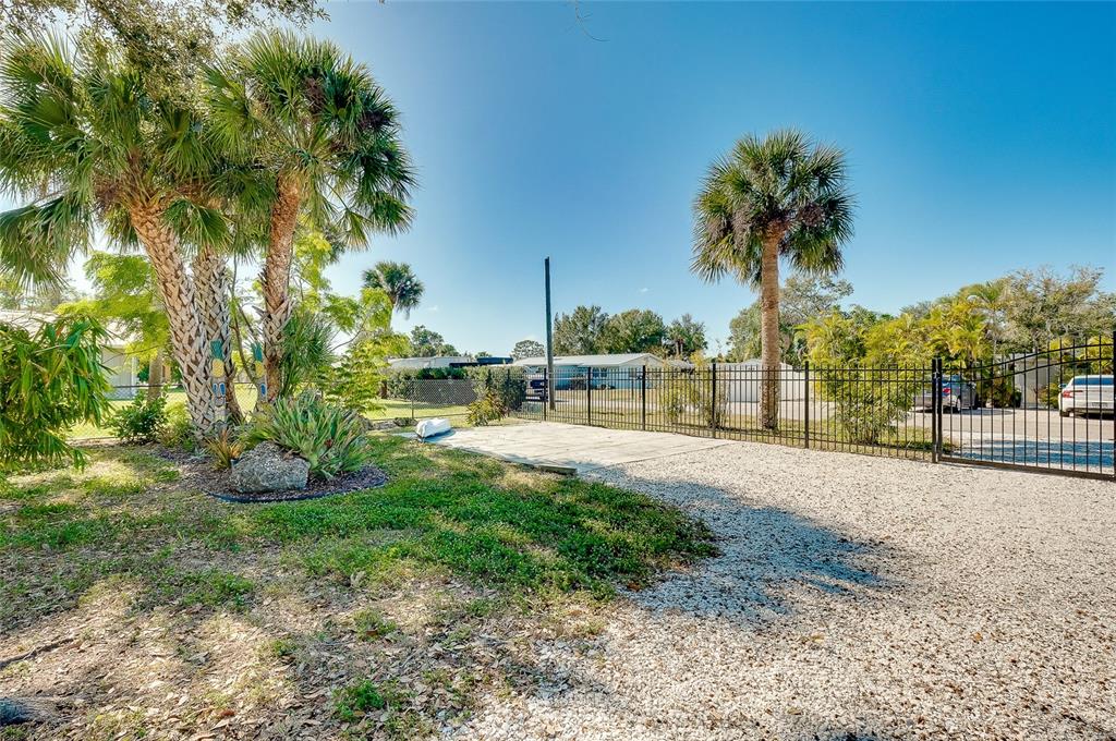 223 Palmetto Road West Nokomis, FL 34275 - Photo 70 of 100 a view of a yard with palm tree