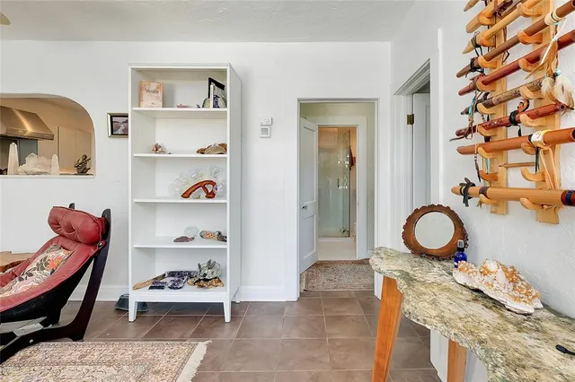 a living room with furniture and kitchen view