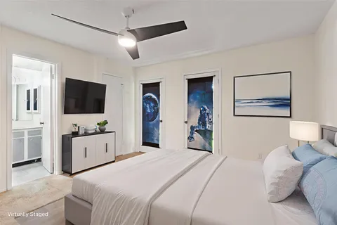 a view of an empty room with a chandelier fan