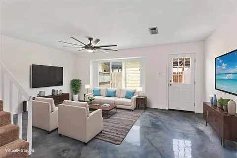 a living room with furniture and a flat screen tv