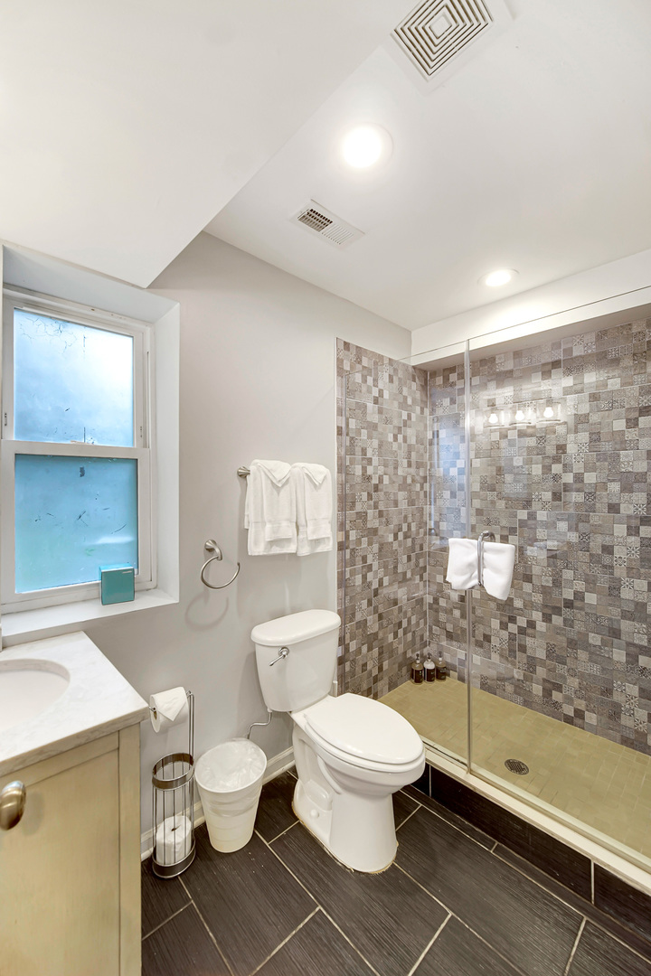 2123 West Adams Street Chicago, IL 60612 - Photo 15 of 30 a white toilet sitting next to a bathroom sink