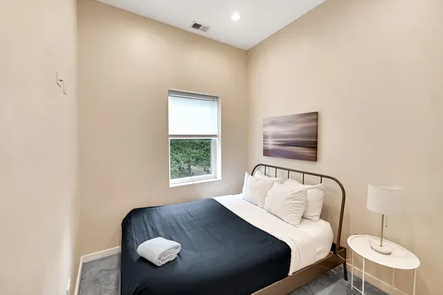 a bedroom with a bed and window