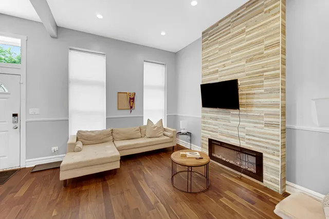 a living room with furniture wooden floor and a fireplace