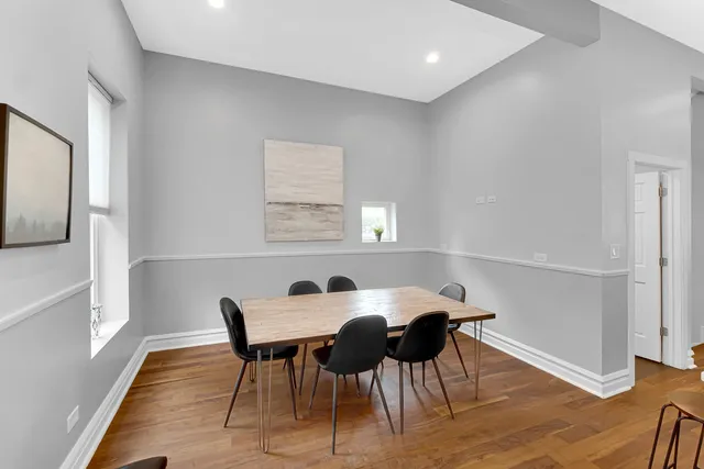 a view of a dining room with furniture and wooden floor