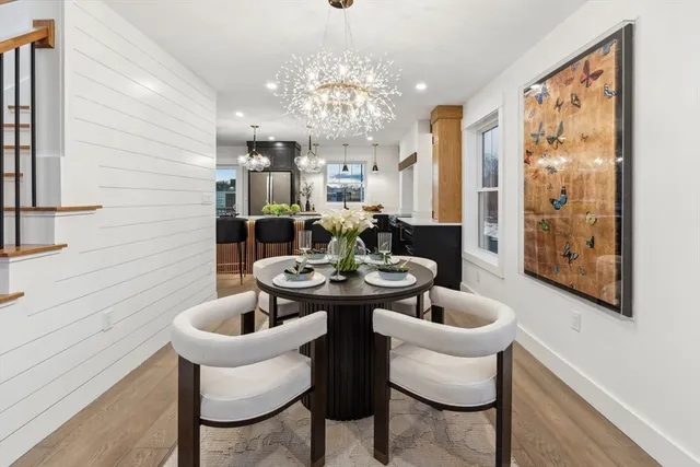 a view of a dining room with furniture and chandelier