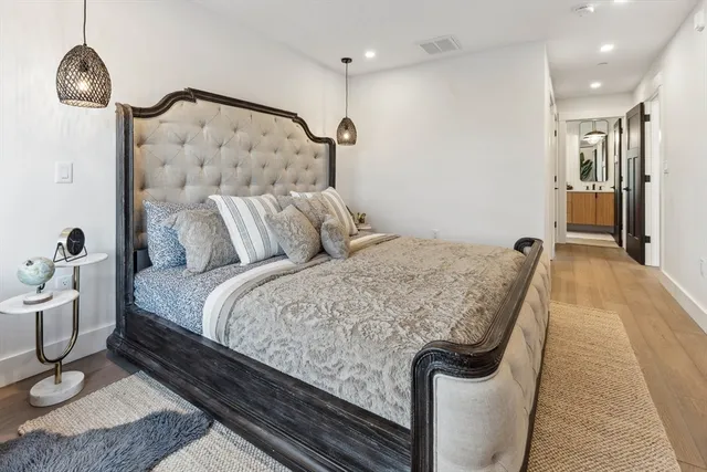 a bed sitting in a bedroom and chair