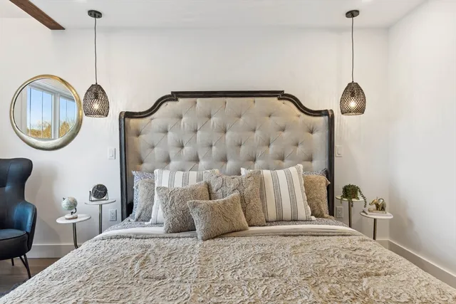 a bedroom with a bed and a chandelier