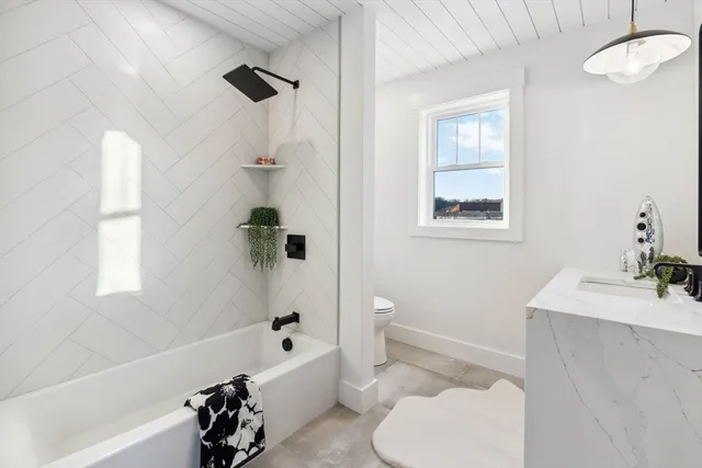 a bathroom with a sink a toilet and a bathtub