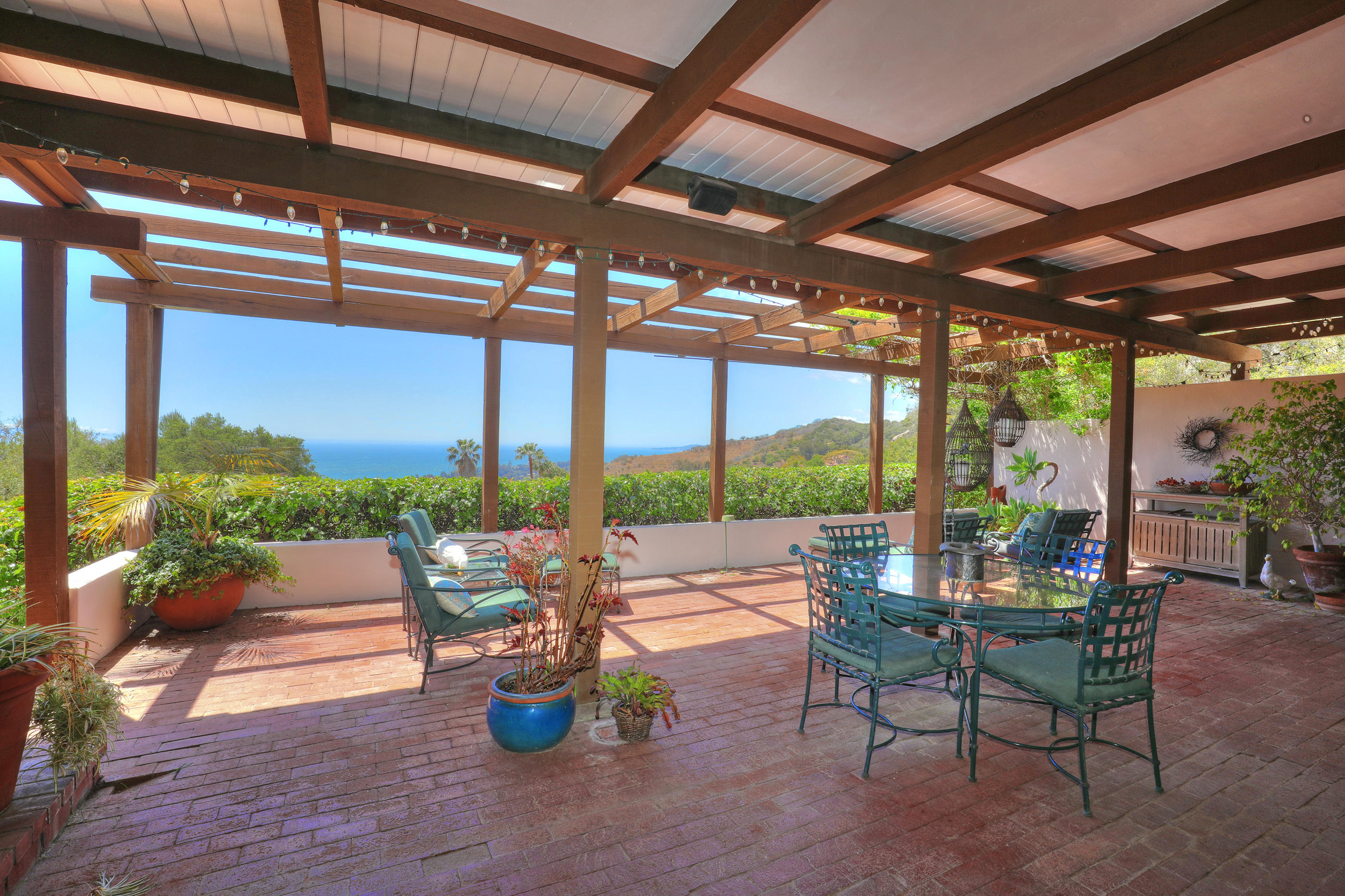 a dining room with furniture and a garden view