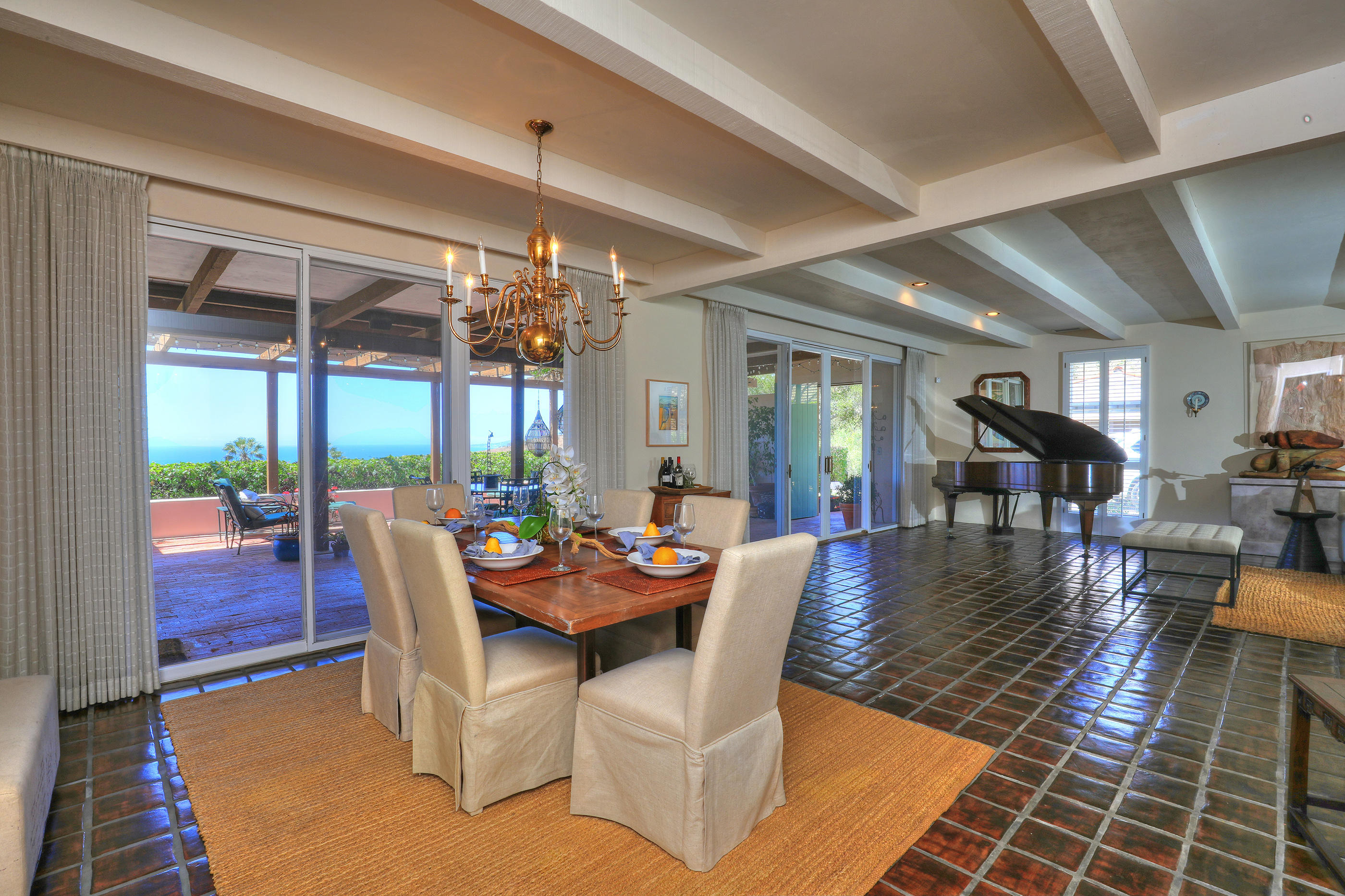 1986 Arriba Street Carpinteria, CA 93013 - Photo 11 of 35 a dining room with furniture a rug and a floor to ceiling window