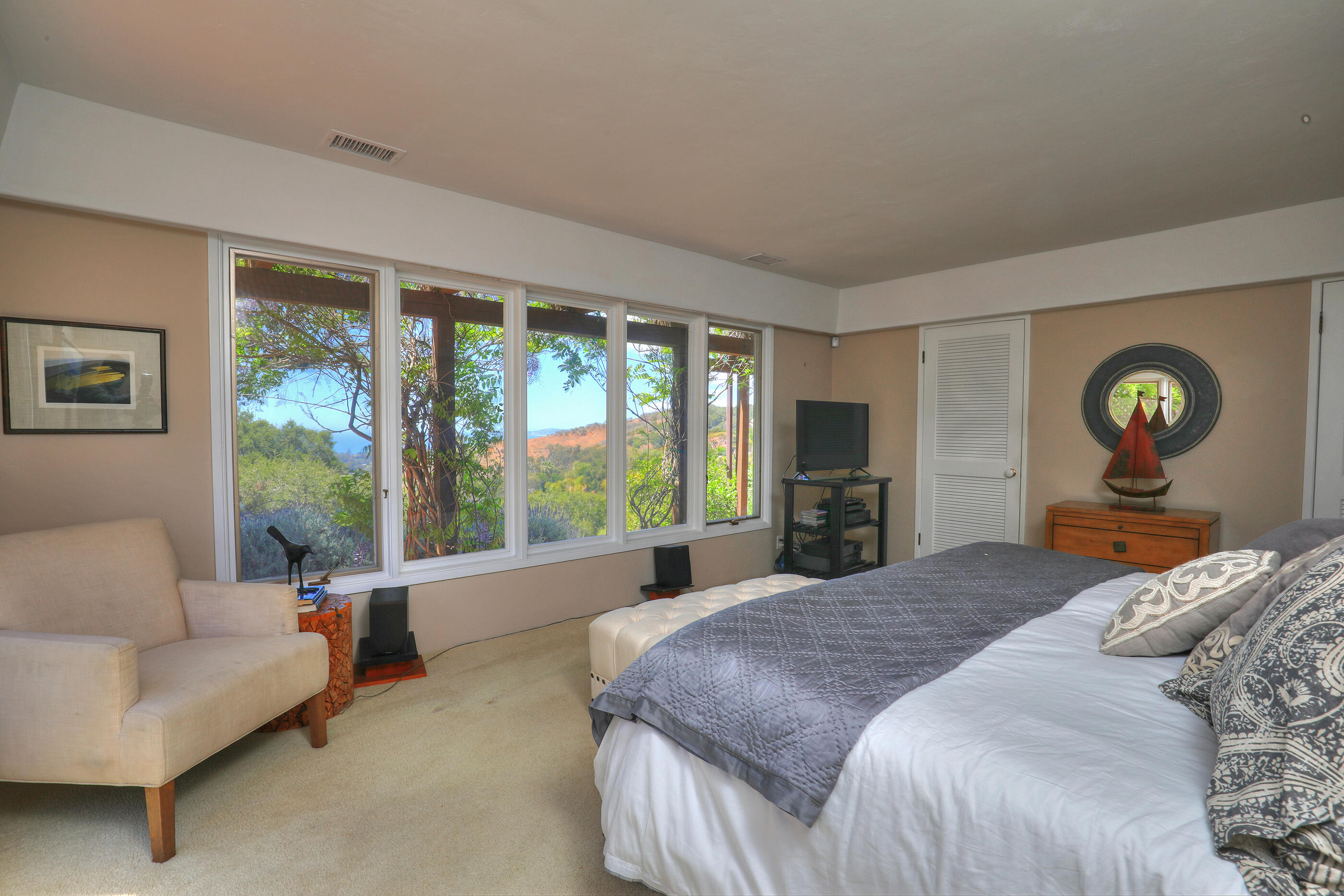 1986 Arriba Street Carpinteria, CA 93013 - Photo 17 of 35 a bedroom with a large bed and a large window