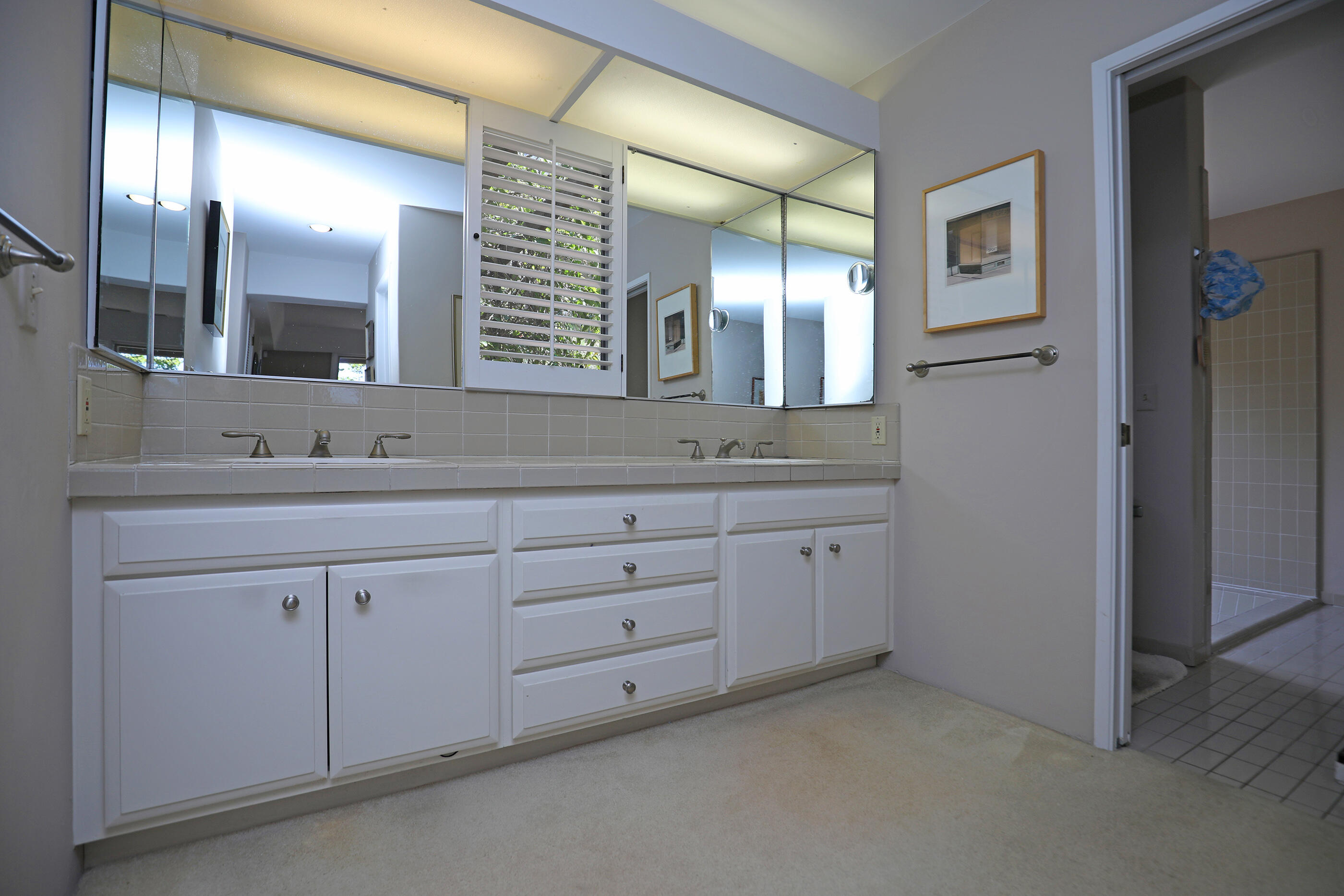 1986 Arriba Street Carpinteria, CA 93013 - Photo 18 of 35 a bathroom with a double vanity sink and a mirror