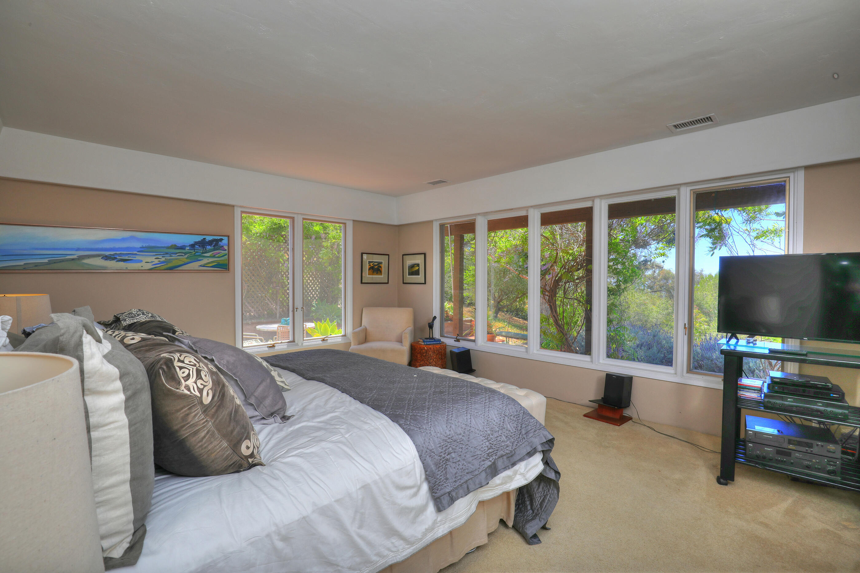 1986 Arriba Street Carpinteria, CA 93013 - Photo 21 of 35 a bedroom with a bed and a flat tv screen next to a window