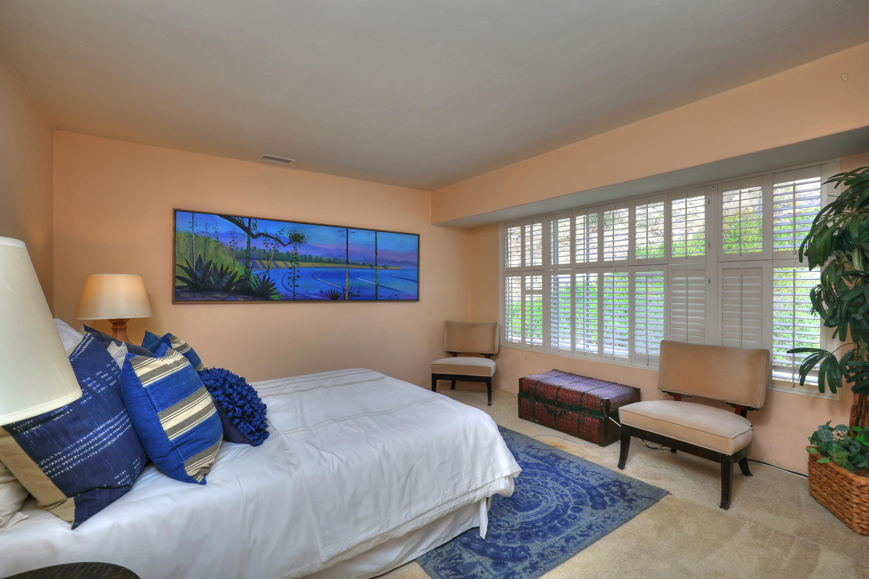 1986 Arriba Street Carpinteria, CA 93013 - Photo 25 of 35 a bedroom with a bed and a couch next to a window