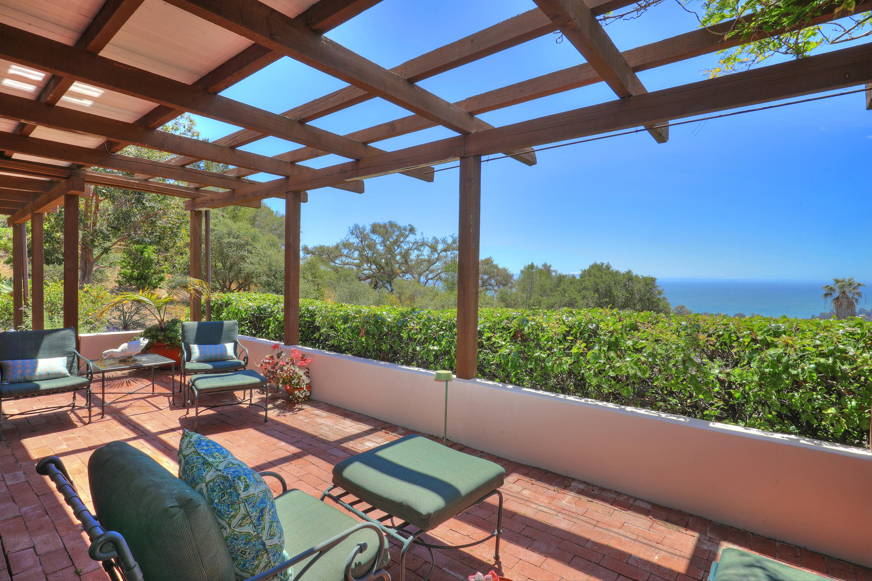 1986 Arriba Street Carpinteria, CA 93013 - Photo 27 of 35 a view of a patio with lawn chairs under an umbrella