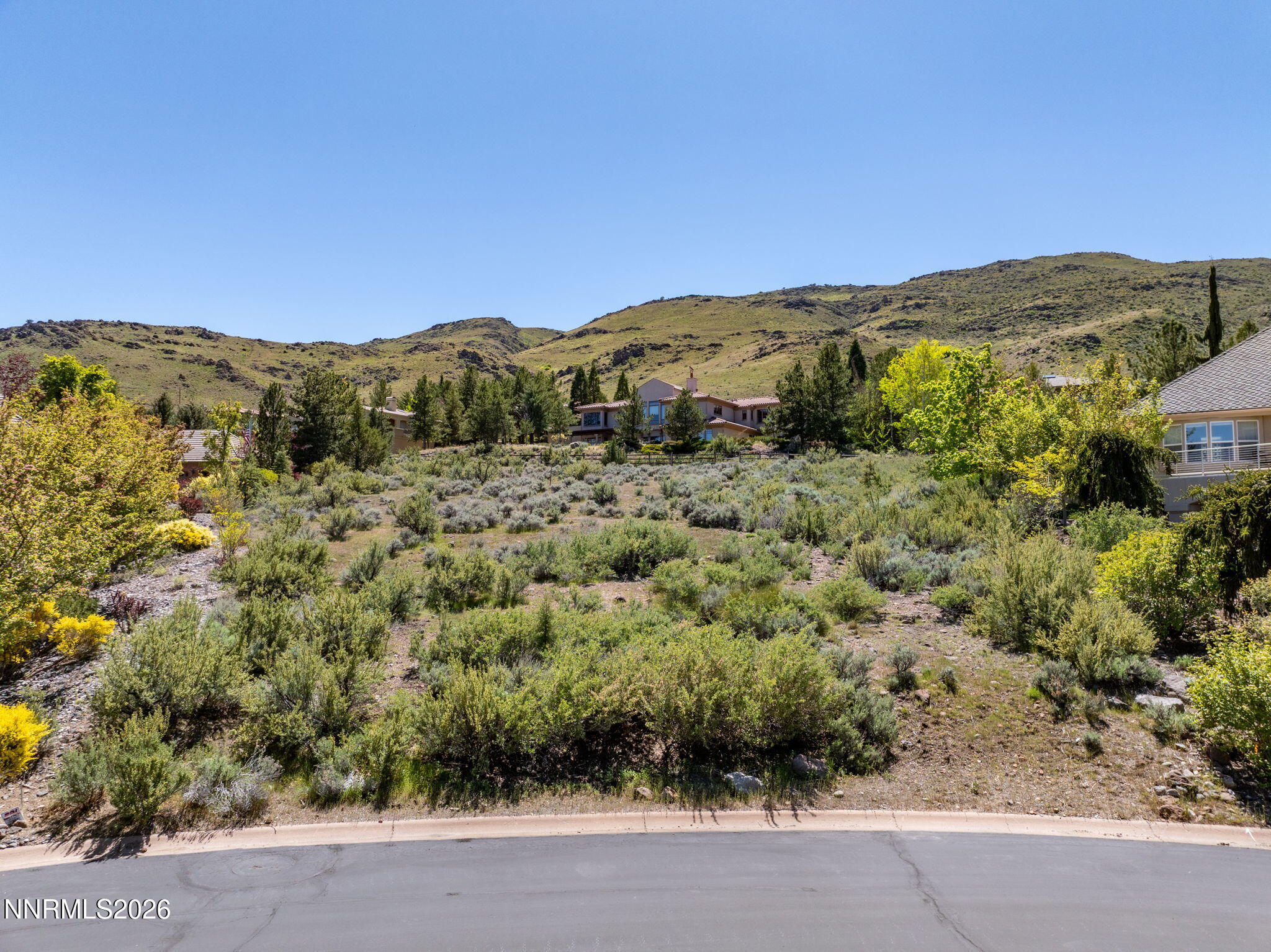 60 Promontory Pointe Reno, NV 89519 - Photo 2 of 18 a view of a lush green field with mountains in the background
