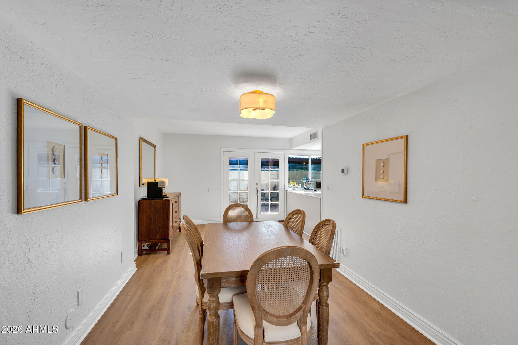 4217 North Miller Road Scottsdale, AZ 85251 - Photo 13 of 30 a view of a dining room with furniture window and wooden floor